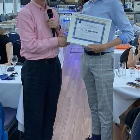 Prof. Roger Jones of Manchester University presents Joe Bateman with the poster prize at the VHEE'2023 conference dinner